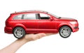 Woman hand holding a big red car toy Audi on white background Royalty Free Stock Photo