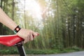 Woman hand holding bike seat wearing health sensor smart watch Royalty Free Stock Photo