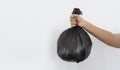 Woman hand holding black garbage bag with isolated on white background Royalty Free Stock Photo