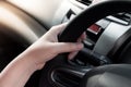 woman hand holding on black steering wheel