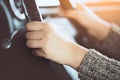 Woman hand holding on black steering wheel while driving a car Royalty Free Stock Photo