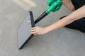 Woman hand holding blower to clean dirty air purifier