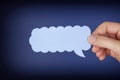 Woman hand holding blue speech bubble Royalty Free Stock Photo