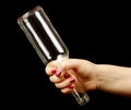 Woman hand holding bottle by it s bottleneck Royalty Free Stock Photo