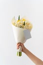 Woman hand holding bouquet of white and yellow daffodils  . Royalty Free Stock Photo