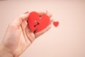 Woman hand holding broken paper red heart on pink background. Love, Wedding and Valentines day.Disappointment,separation Royalty Free Stock Photo