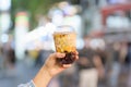 woman hand holding brown sugar boba milk tea with tapioca pearls at night market, famous Taiwanese bubble tea of Taiwan. Street Royalty Free Stock Photo