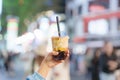 woman hand holding brown sugar boba milk tea with tapioca pearls at night market, famous Taiwanese bubble tea of Taiwan. Street Royalty Free Stock Photo