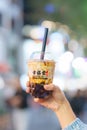 woman hand holding brown sugar boba milk tea with tapioca pearls, Xing Fu Tang brand known for making the best hand crafted brown Royalty Free Stock Photo