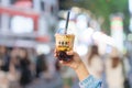 woman hand holding brown sugar boba milk tea with tapioca pearls, Xing Fu Tang brand known for making the best hand crafted brown Royalty Free Stock Photo