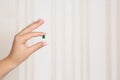Female hand holding pill Royalty Free Stock Photo