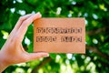 Woman hand holding cardboard card with words Declutter Your Life