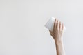 Woman hand holding a cleaning sponge isolated on a gray background Royalty Free Stock Photo