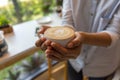 Woman hand holding coffe cup in coffee shop Royalty Free Stock Photo