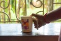 Woman Hand holding coffee cup. Close Up Of Human Hand Holding a Coffee Cup. Female hand hold take away coffee mug At Home. Morning