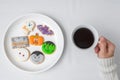 woman hand holding coffee cup during eating funny Halloween Cookies. Happy Halloween day, Trick or Threat, Hello October, fall Royalty Free Stock Photo