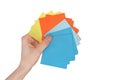 Woman hand holding colorful paper stickers on white background Royalty Free Stock Photo