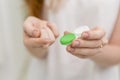 woman hand holding contact lens it s container. High quality photo Royalty Free Stock Photo