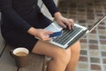 Woman hand holding credit card and laptop close up outside Royalty Free Stock Photo