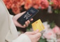 Woman hand holding credit card and using smartphone for online shopping. and are paying online successfully. digital banking, e- Royalty Free Stock Photo