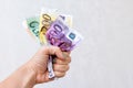 Woman hand holding crumpled euro banknotes. Hand holds bunch of crumpled cash.