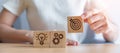 Woman hand holding dartboard above Gear and Lightbulb icon block. business planning process, goal, strategy, target, mission, Royalty Free Stock Photo