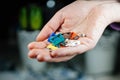 Woman holding colorful amp car fuses defocused background