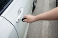 Woman hand holding door car to unlock or lock