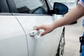 Woman hand holding door car to unlock or lock Royalty Free Stock Photo