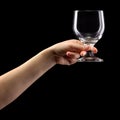 Woman hand holding empty beer glass isolated on black. Royalty Free Stock Photo