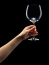 Woman hand holding empty wine glass isolated on black Royalty Free Stock Photo