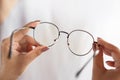 Woman hand hand holding eyeglasses closeup ,eye care concept Royalty Free Stock Photo