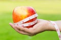 Woman hand holding fresh apple with measuring tape Royalty Free Stock Photo