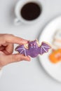 Woman hand holding funny Halloween Cookie during drinking coffee. Happy Halloween day, Trick or Threat, Hello October, fall autumn Royalty Free Stock Photo