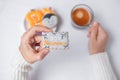 Woman hand holding funny Halloween Cookie during drinking coffee. Happy Halloween day, Trick or Threat, Hello October, fall autumn Royalty Free Stock Photo