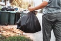 woman hand holding garbage in black bag for cleaning in to trash Royalty Free Stock Photo