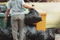 woman hand holding garbage in black bag for cleaning in to trash Royalty Free Stock Photo