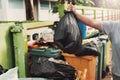 woman hand holding garbage in black bag for cleaning in to trash Royalty Free Stock Photo