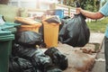 woman hand holding garbage in black bag for cleaning in to trash