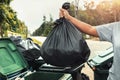 woman hand holding garbage in black bag for cleaning in to trash Royalty Free Stock Photo