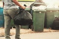 woman hand holding garbage in black bag for cleaning in to trash Royalty Free Stock Photo