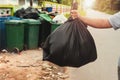 woman hand holding garbage in black bag for cleaning in to trash Royalty Free Stock Photo