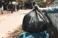 woman hand holding garbage bag put in to trash Royalty Free Stock Photo