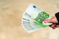 Woman hand holding and giving money. World money concept, close up of 100 EURO banknote, photo of EUR currency isolated. Hand Royalty Free Stock Photo