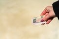 Woman hand holding and giving money. World money concept, close up of USD banknote, photo of American Dollars currency. Hand