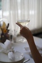 Woman hand holding glass with martini cocktail, close-up Royalty Free Stock Photo