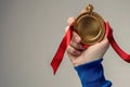 woman hand, holding gold medal on white background Royalty Free Stock Photo