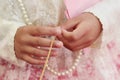 Woman hand holding gold necklace in Thai engagement ceremony.Thai wedding culture.