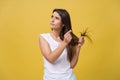 Woman hand holding her long hair with looking at damaged splitting ends of hair care problems. Royalty Free Stock Photo