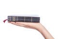 Woman hand holding the Holy Bible on white background